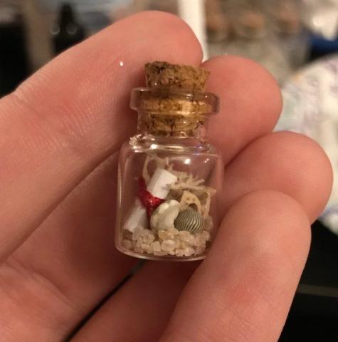 Mini decorative bottle in someone's hand