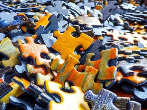 A pile of orange and blue puzzle pieces.