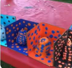 Painted pumpkins on cardboard