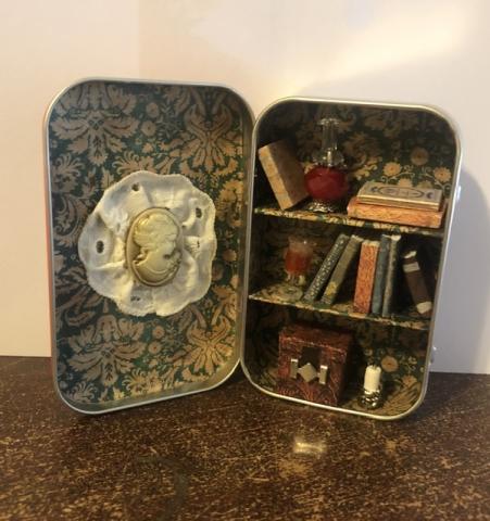 Tin with a mini bookshelf created on it