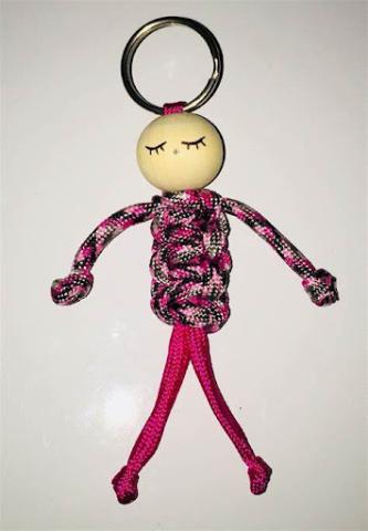 a paracord person keychain with a pink outfit