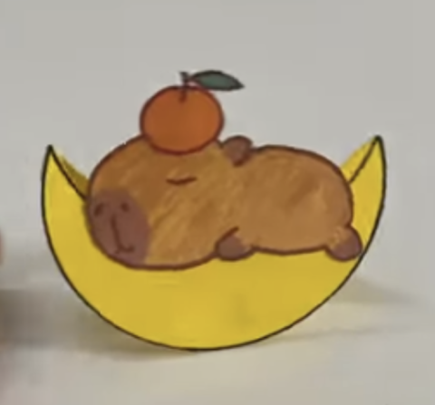 Paper capybara on a moon with an orange