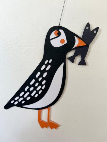 Black and white puffin with fish