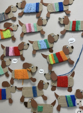 cardboard dogs with yarn sweaters
