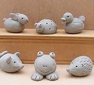 6 small animal figures made of out grey clay.