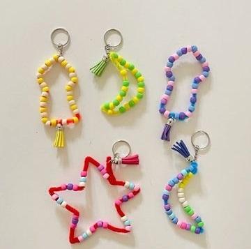 Keychains in various shapes made out of pipe cleaners and many colored pony beads