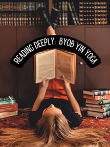 A woman lying on the floor and reading a book.