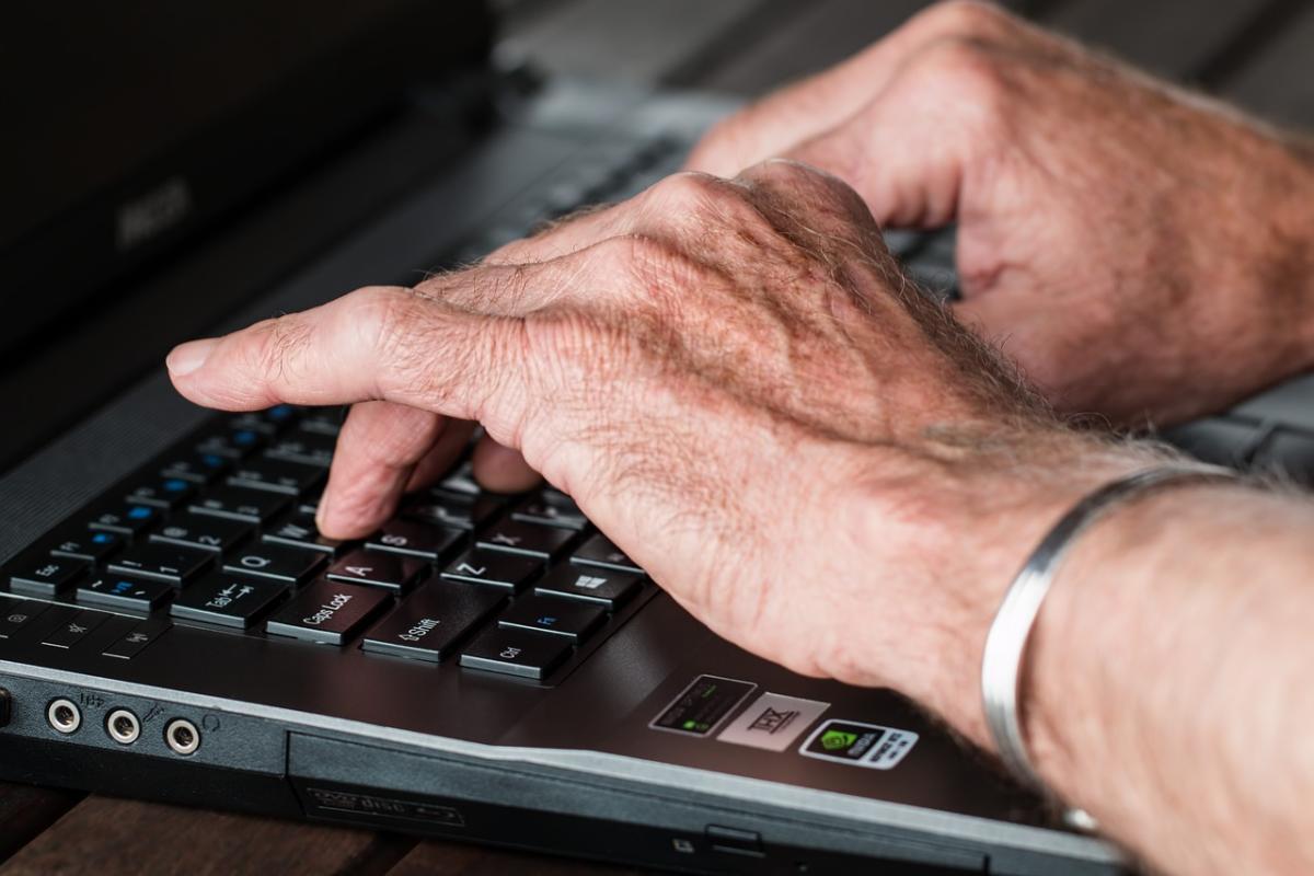 A person typing on a laptop.