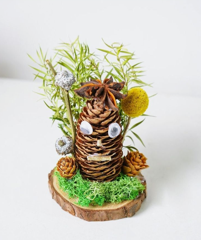 Decorated pinecone to look like a figure