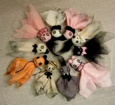 A variety of spooky dolls in a circle