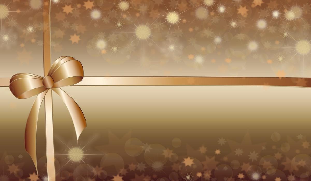 Image of a gold background with sparkles and a gold ribbon tied in a bow