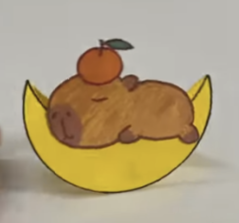 Paper capybara on a moon with an orange